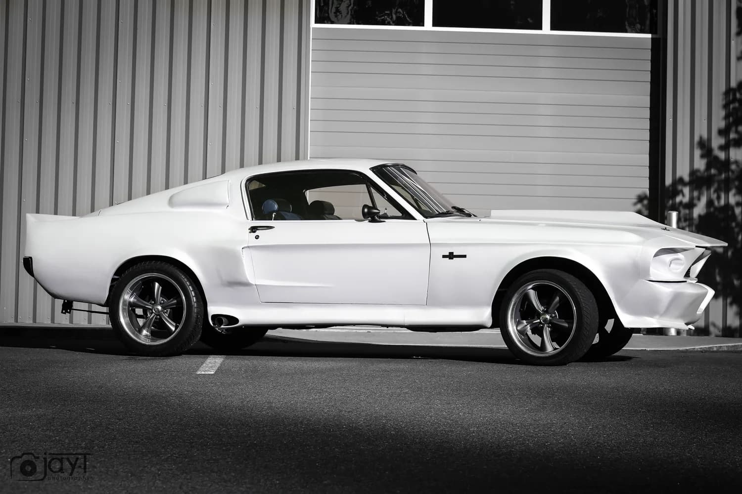 Side profile of a Ford Mustang Fastback finished in satin white vinyl wrap by Oly Wraps