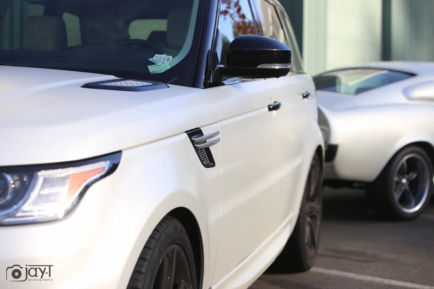 Front quarter detail of a Range Rover Sport wrapped in satin pearl white vinyl